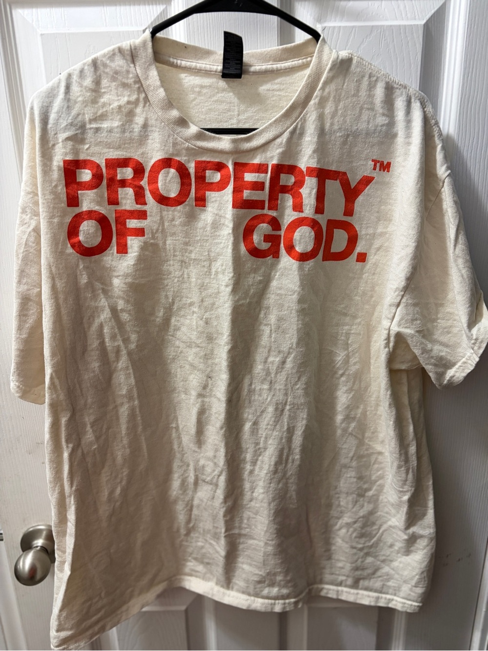 Gildan Cream Short Sleeve Tee with orange "PROPERTY OF GOD." Print